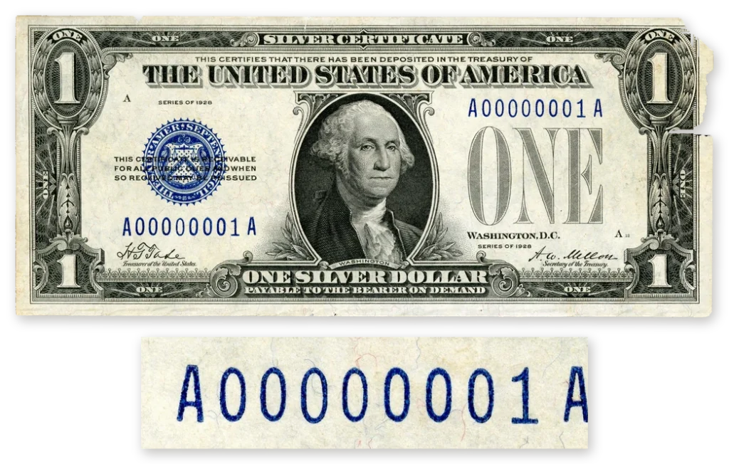 A Series 1928 $1 silver certificate with serial number A00000001A, above an enlarged close-up of the serial number