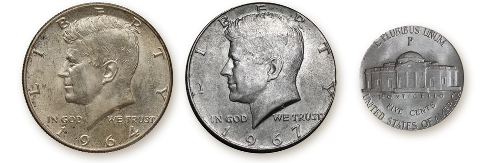 A 1964 Kennedy half dollar (90% silver), a 1967 Kennedy half dollar (40% silver) and the reverse of a 1945-P Jefferson war nickel (35% silver) with the large P mint mark