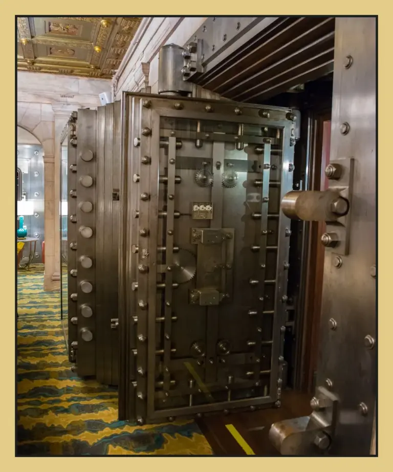 Massive steel bank vault doors in a historic marble safe deposit room