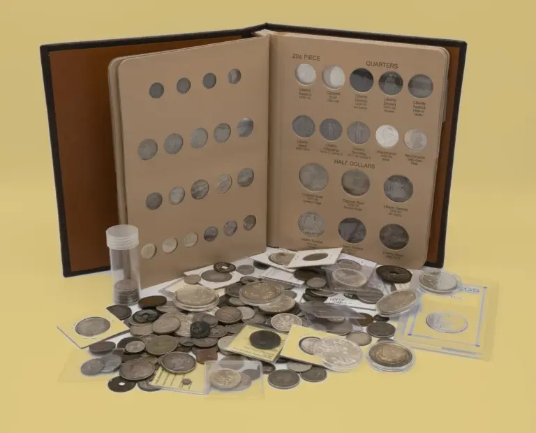 Open U.S. type coin album with quarters and half dollars, a coin tube, loose silver coins, coins in flips and a graded coin on a gold background