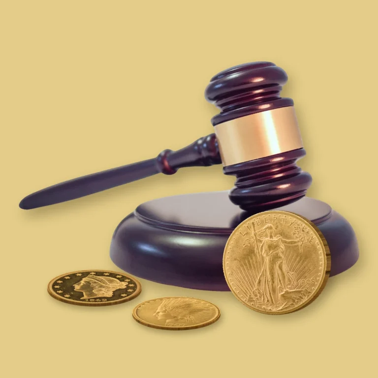 Auctioneer's wooden gavel on its sound block with a 1908 Saint-Gaudens double eagle, 1849 Liberty Head double eagle and 1907 Indian Head eagle, representing auction consignment of rare coins