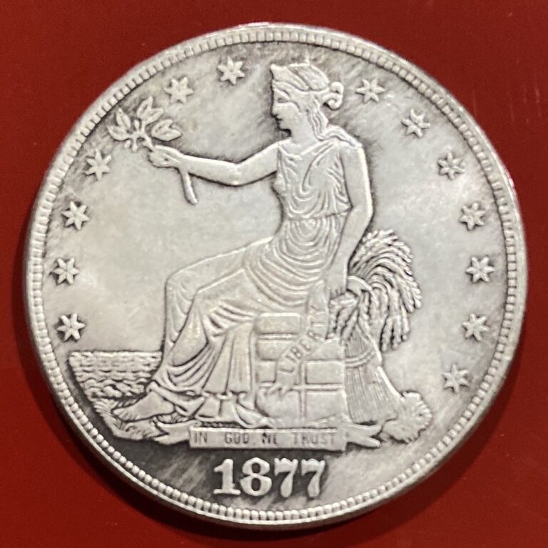 Counterfeit 1877 trade dollar obverse on a red background