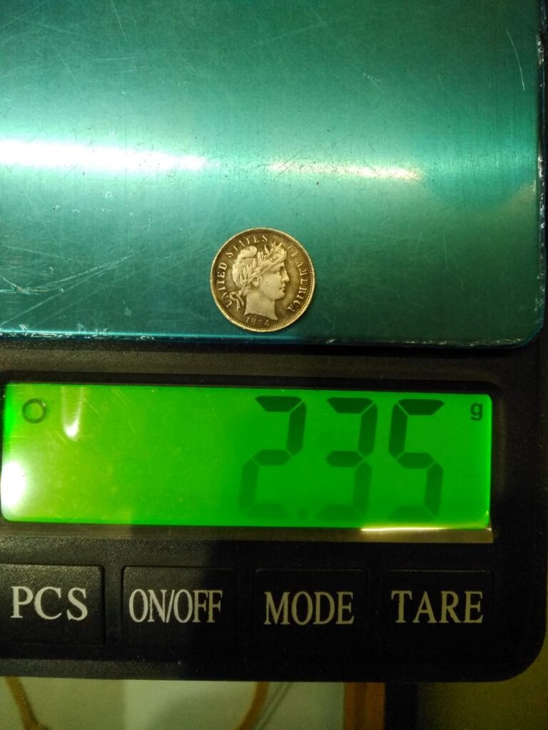 Fake 1894 Barber dime on a digital scale reading 2.35 grams