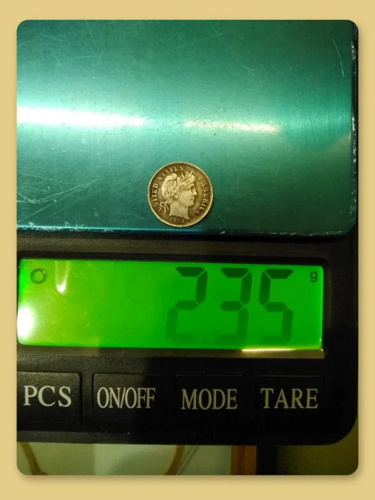 Fake 1894 Barber dime on a digital scale reading 2.35 grams