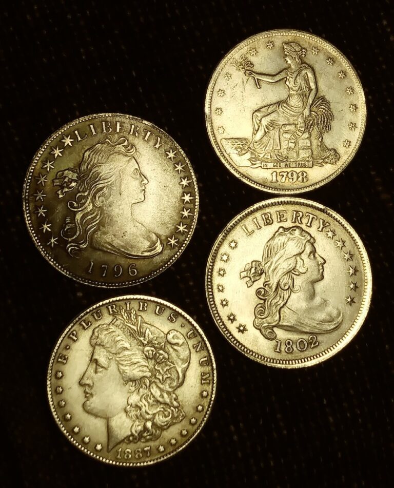 Four brassy yellow counterfeit early U.S. silver dollars