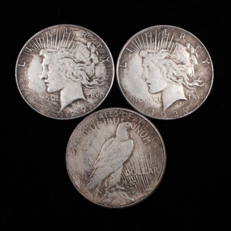 Three counterfeit Peace silver dollars showing obverse and reverse