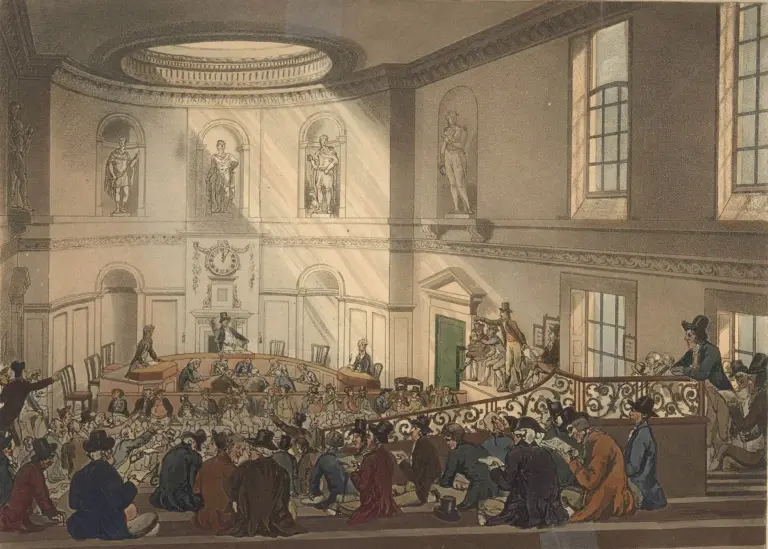 Hand-colored 1808 aquatint of a crowded auction in the India House sale room in London, with bidders seated before the auctioneer's rostrum