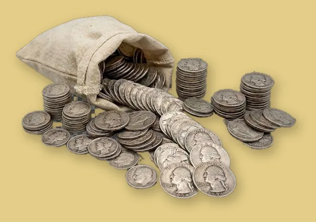 Canvas bag spilling 90% silver Washington quarters and dimes, with stacks of silver coins beside it