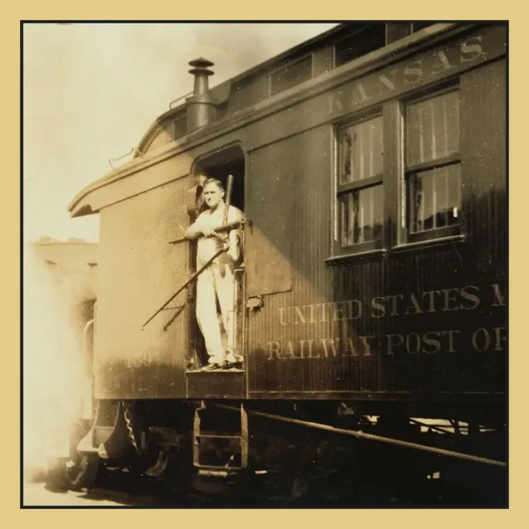 Historic photo of a clerk in the doorway of a United States Mail railway post office car