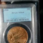 A counterfeit 1928 Saint-Gaudens gold coin in a fake PCGS slab, an example of sophisticated counterfeit coins.
