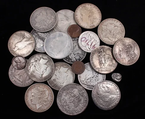 A pile of various fake and counterfeit coins identified by our experts, showing the importance of professional authentication.