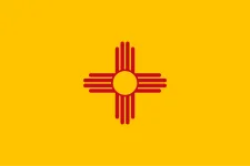 The New Mexico state flag, representing our service as a trusted New Mexico coin dealer.