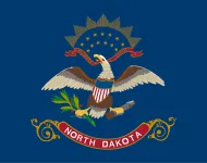 north-dakota-state-flag The North Dakota state flag, representing our service as a trusted North Dakota coin dealer.