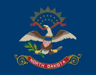 The North Dakota state flag, representing our service as a trusted North Dakota coin dealer.